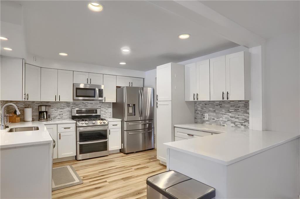 9652 Shirley Drive Allison Park, PA 15101 - Photo 15 of 49 a kitchen with stainless steel appliances a stove a sink a refrigerator white cabinets and a refrigerator