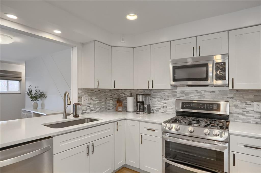 9652 Shirley Drive Allison Park, PA 15101 - Photo 17 of 49 a kitchen with stainless steel appliances granite countertop a sink a stove a microwave and cabinets