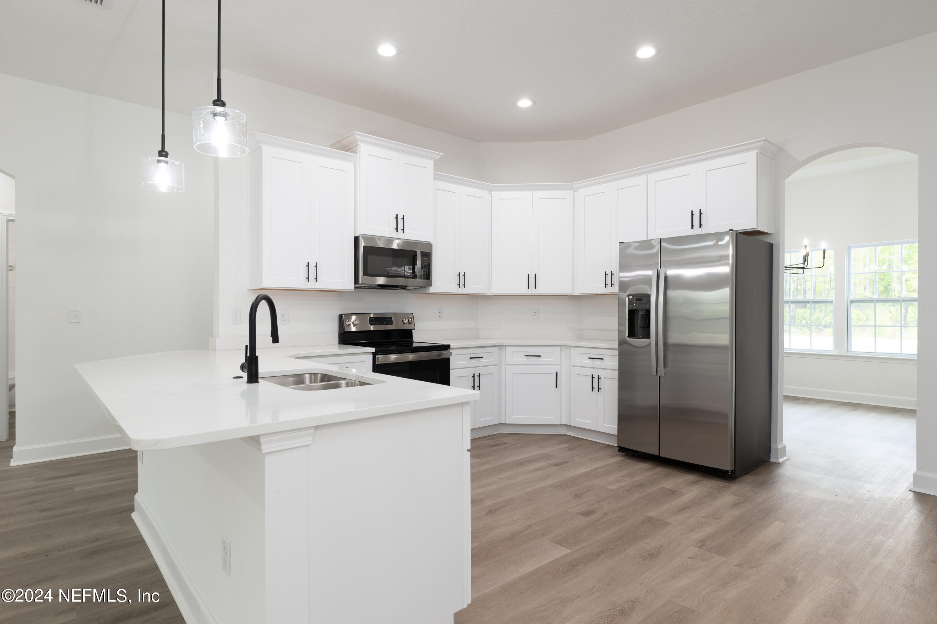 489 Kay Road Middleburg, FL 32068 - Photo 12 of 36 a kitchen with stainless steel appliances a refrigerator sink and microwave