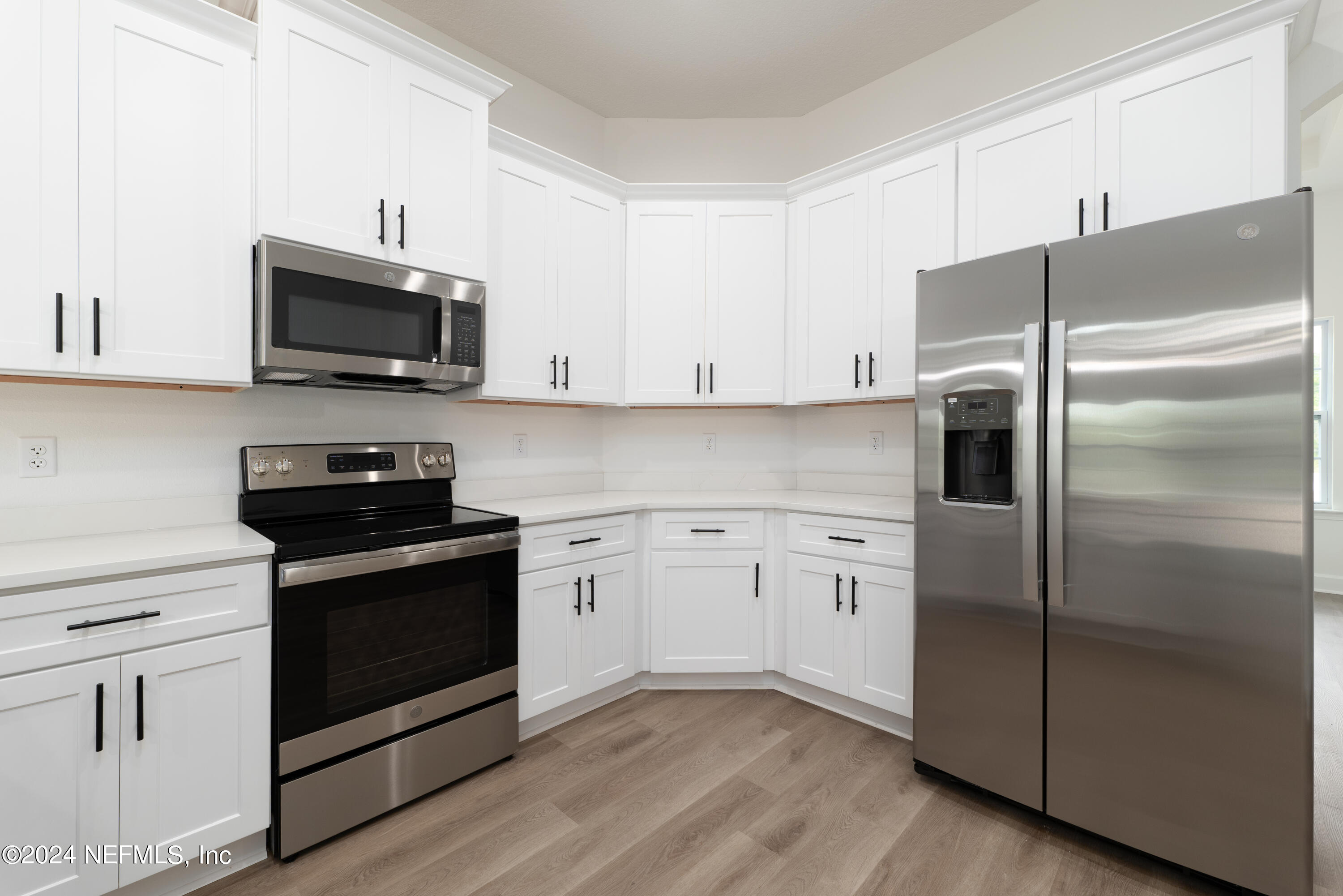 489 Kay Road Middleburg, FL 32068 - Photo 14 of 36 a kitchen with white cabinets stainless steel appliances and a sink