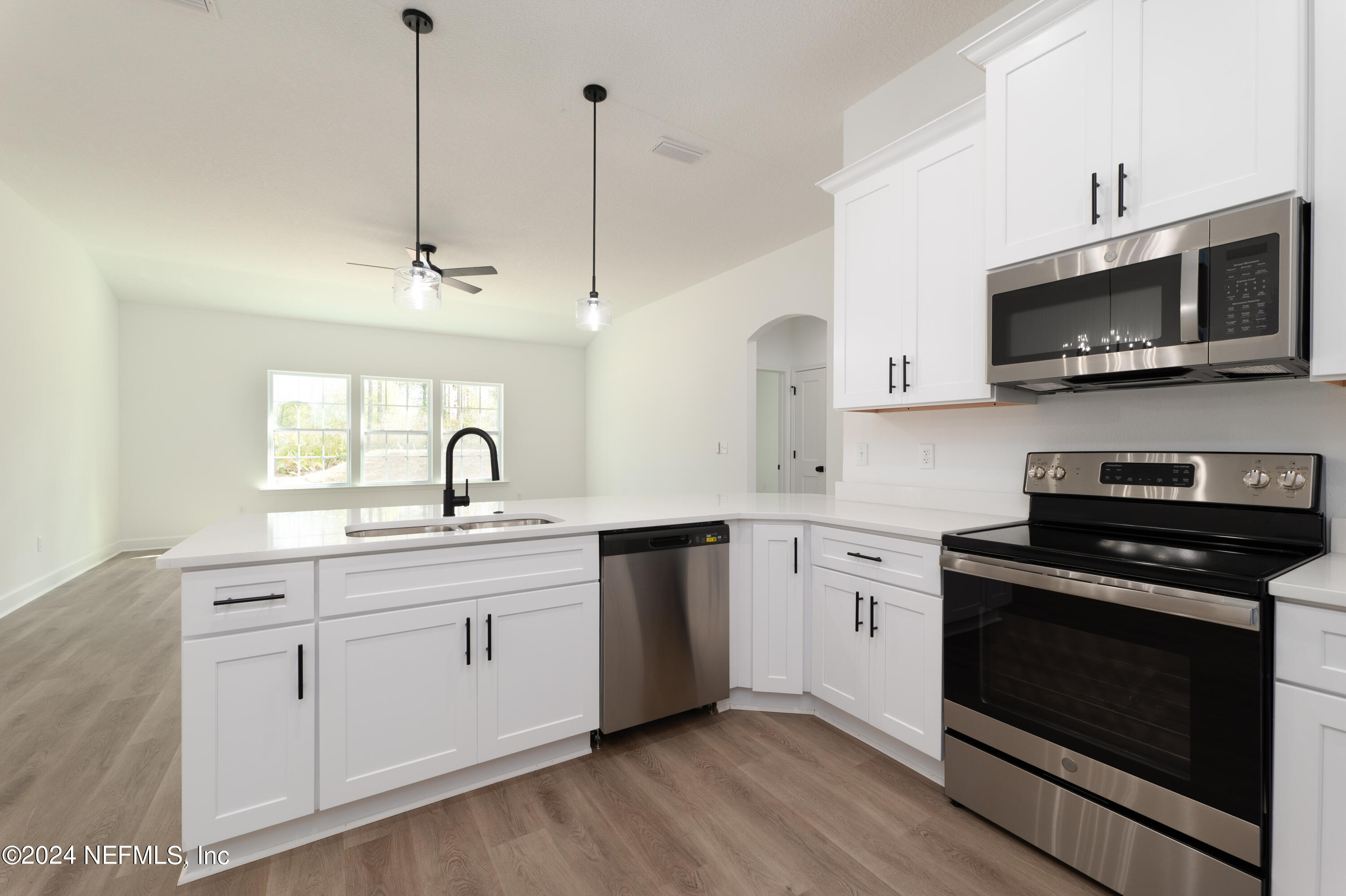 489 Kay Road Middleburg, FL 32068 - Photo 15 of 36 a kitchen with stainless steel appliances a stove a sink and microwave