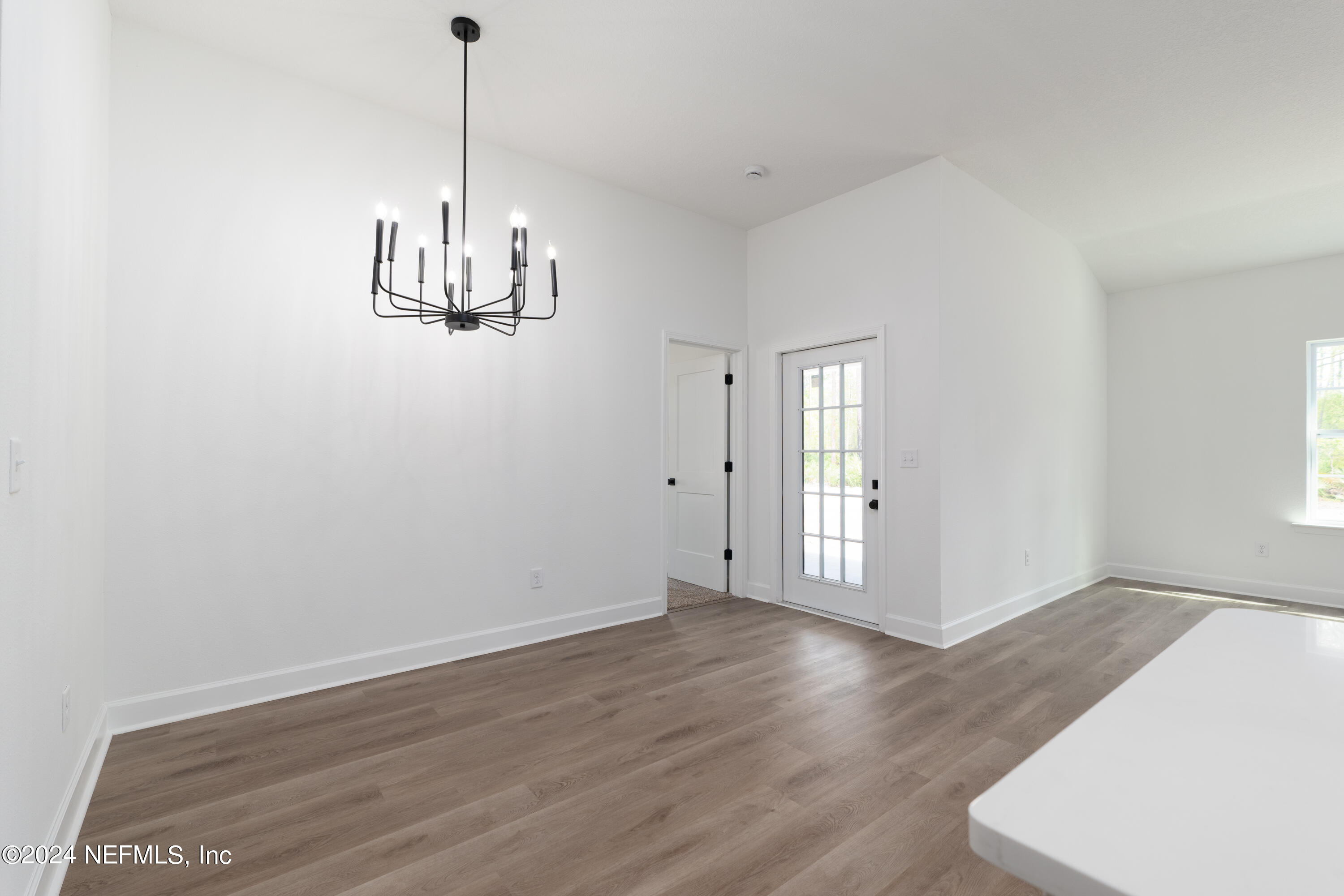 489 Kay Road Middleburg, FL 32068 - Photo 16 of 36 a view of empty room with wooden floor and window