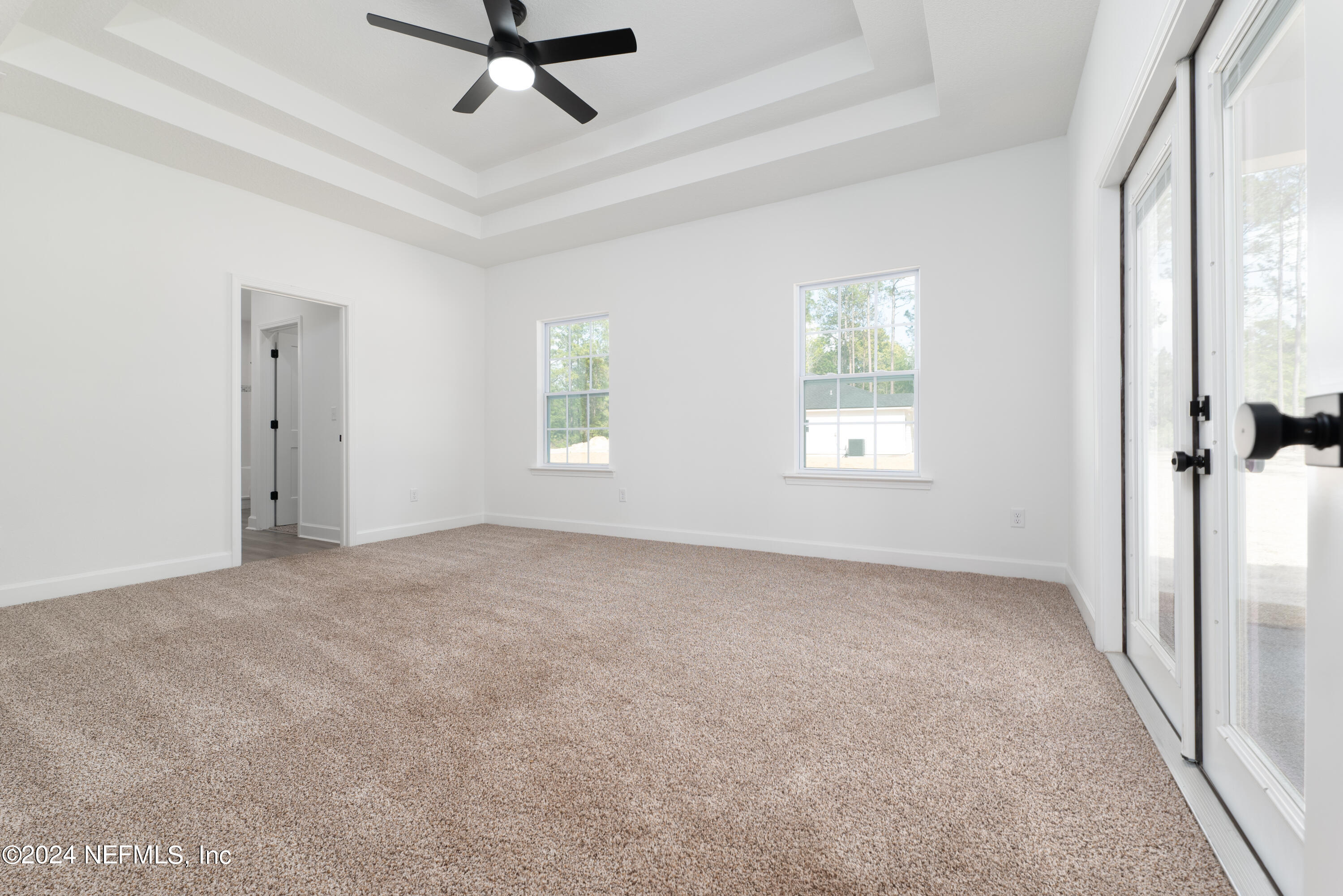 489 Kay Road Middleburg, FL 32068 - Photo 19 of 36 a view of a livingroom with a ceiling fan & windows