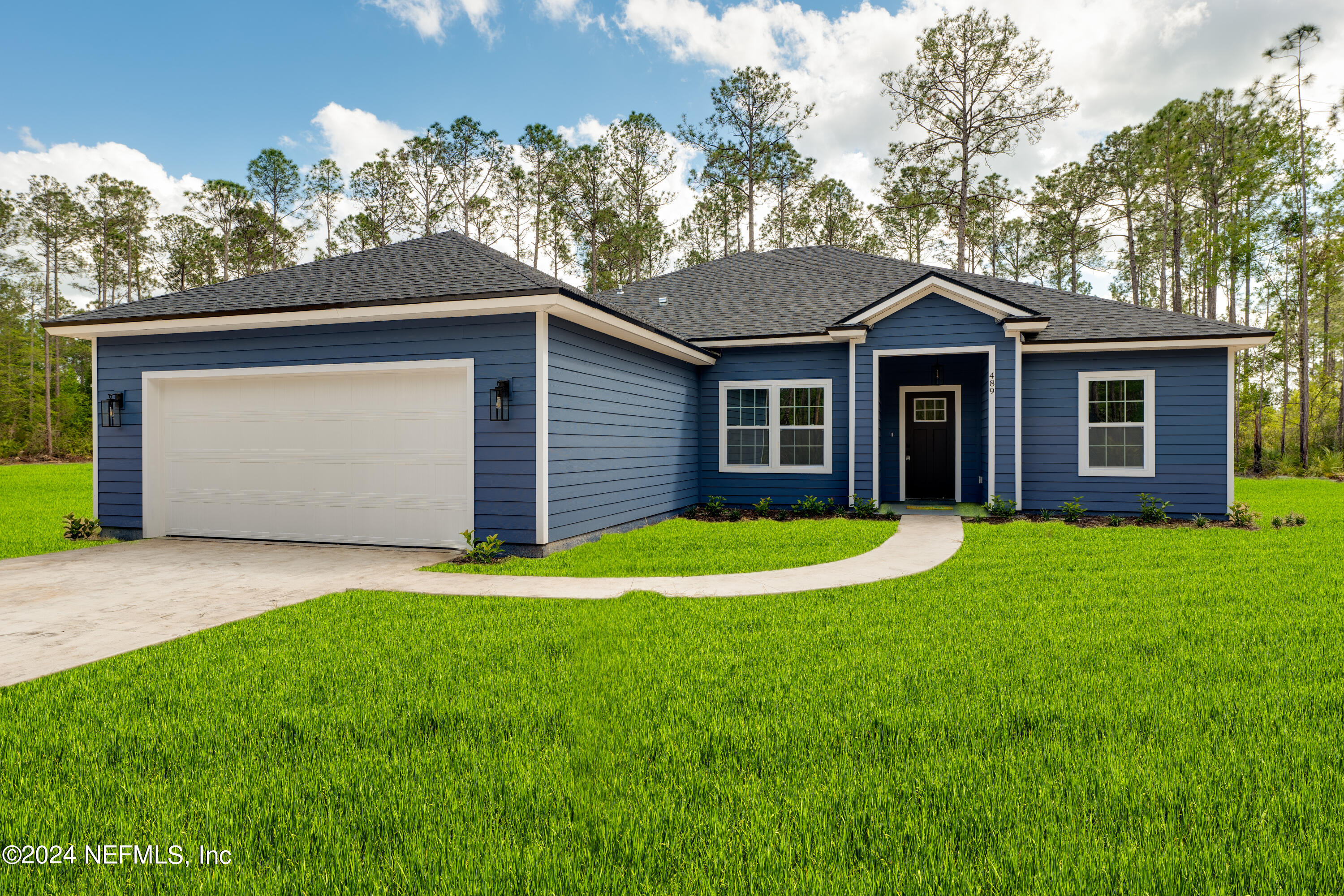 489 Kay Road Middleburg, FL 32068 - Photo 2 of 36 a front view of a house with a yard and garage