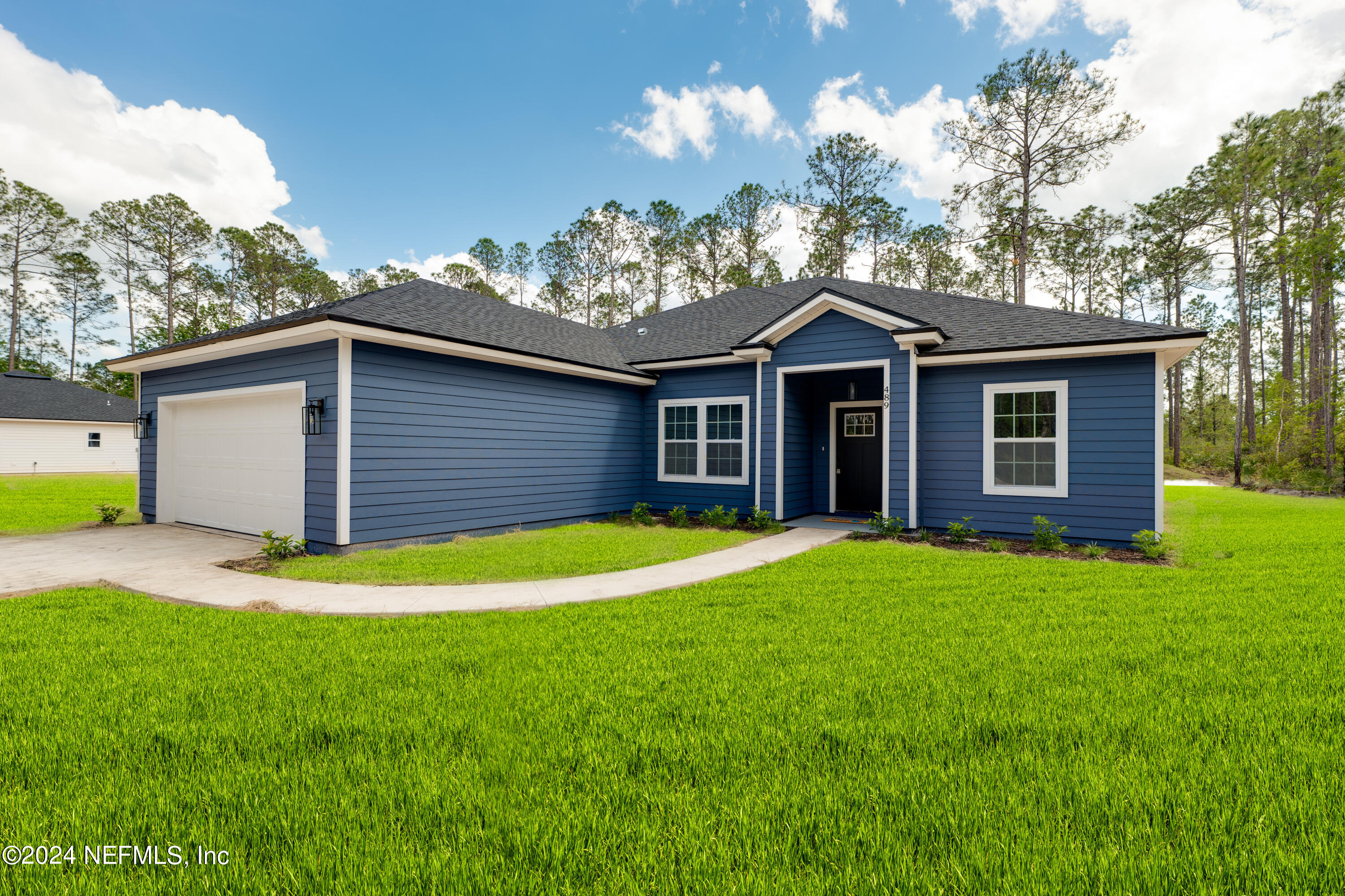 489 Kay Road Middleburg, FL 32068 - Photo 3 of 36 a front view of a house with a yard and garage