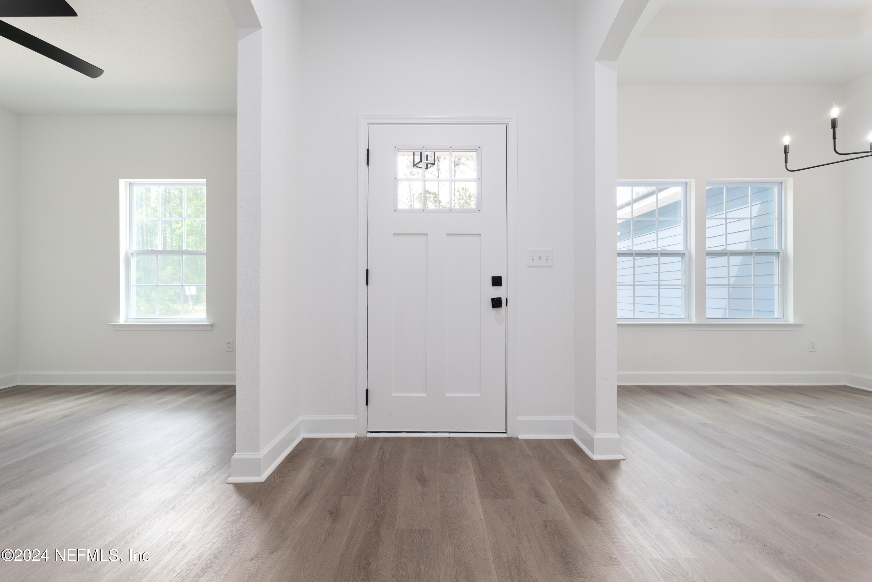 489 Kay Road Middleburg, FL 32068 - Photo 5 of 36 an empty room with wooden floor and windows