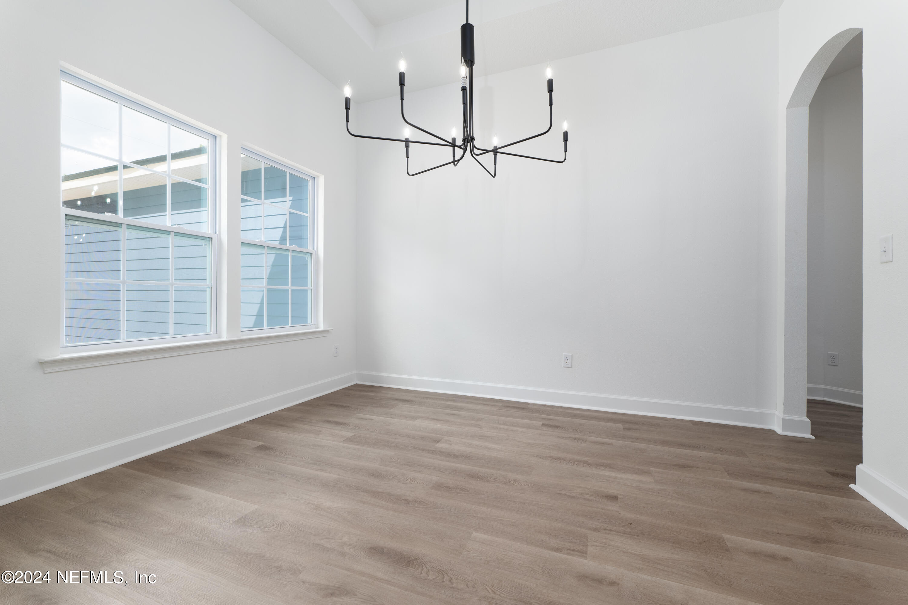 489 Kay Road Middleburg, FL 32068 - Photo 8 of 36 a view of an empty room with wooden floor and windows