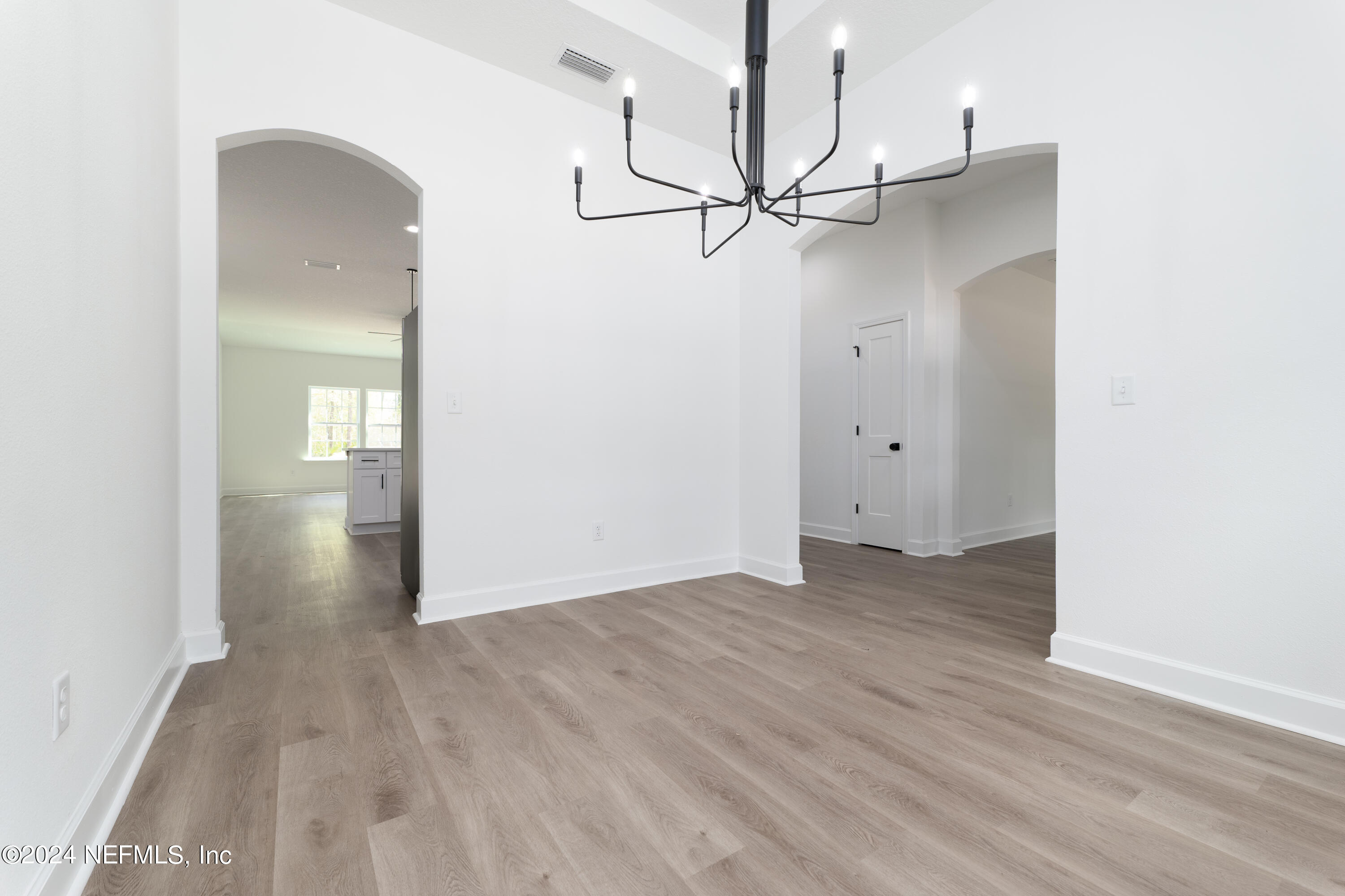 489 Kay Road Middleburg, FL 32068 - Photo 10 of 36 an empty room with wooden floor and door