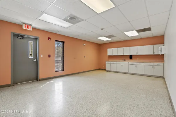 an empty room with natural light and closet
