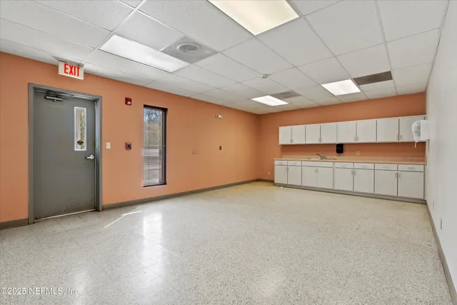 an empty room with natural light and closet