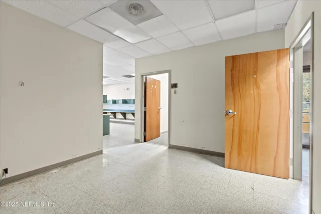 a view of a kitchen with a refrigerator and a sink