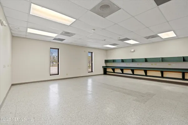 a view of an empty room with two windows