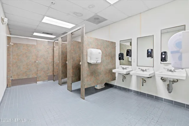 a spacious bathroom with double vanity and a shower