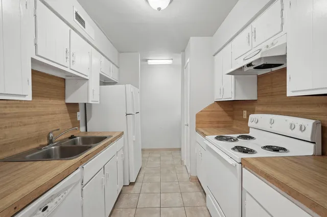 a kitchen that has a sink and a stove