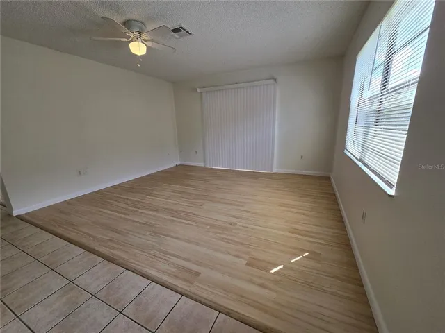 wooden floor in an empty room with a window