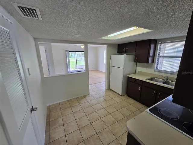 a kitchen with stainless steel appliances a refrigerator and a stove top oven
