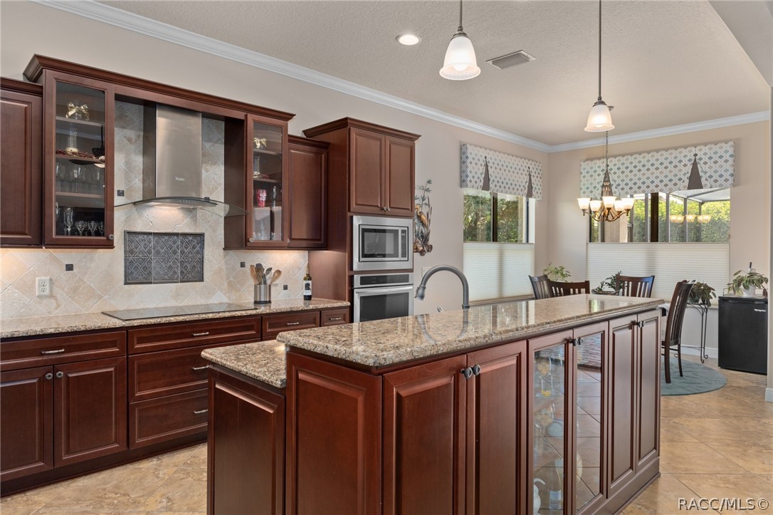 2015 North Rhodes Point Hernando, FL 34442 - Photo 13 of 82 The classic Crown Molding even extends into the kitchen. Another unique feature is the built in storage and display cabinet on the Great Room side of the Kitchen Island, adding that extra special touch of class.