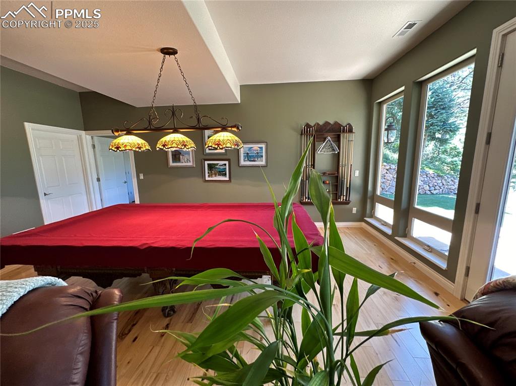 1240 Oak Ridge Road Manitou Springs, CO 80829 - Photo 13 of 17 a view of a dining room with furniture wooden floor and a chandelier