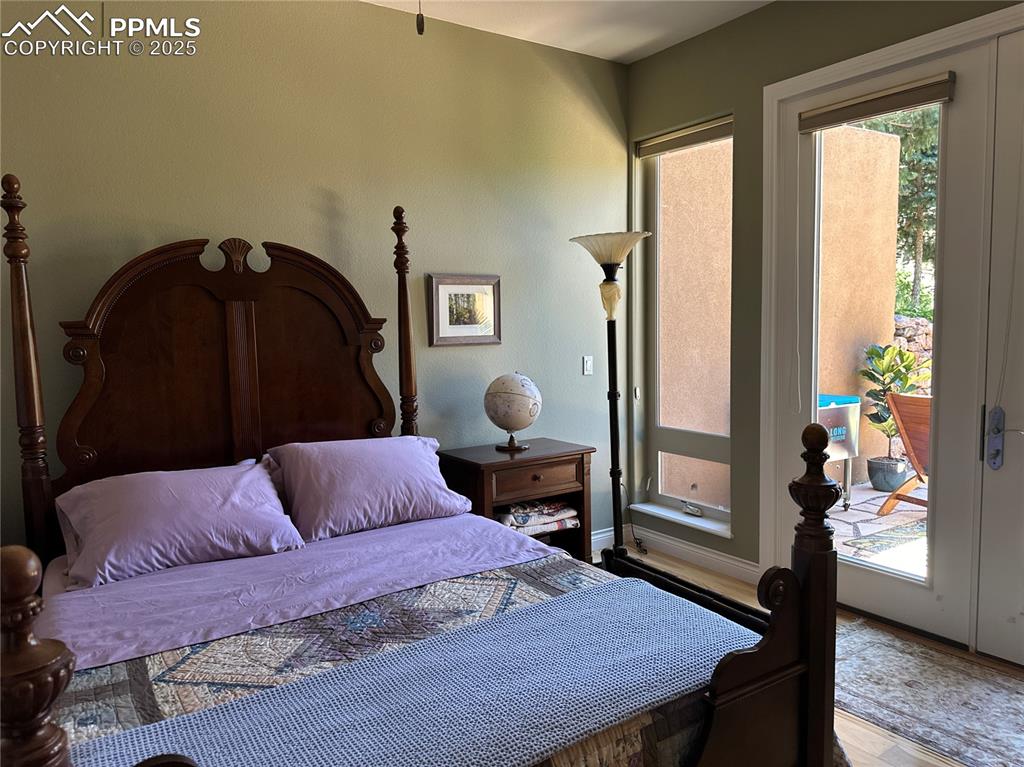 1240 Oak Ridge Road Manitou Springs, CO 80829 - Photo 16 of 17 a bedroom with a bed and wooden floor