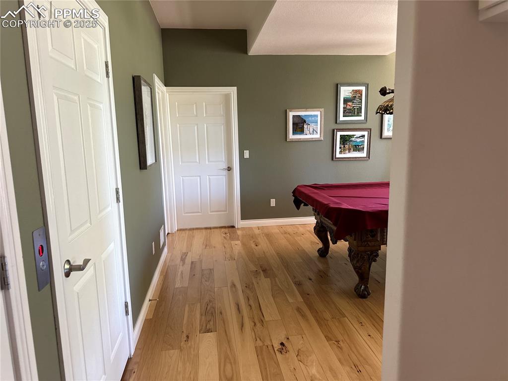 1240 Oak Ridge Road Manitou Springs, CO 80829 - Photo 17 of 17 a view of a hallway with wooden floor and furniture
