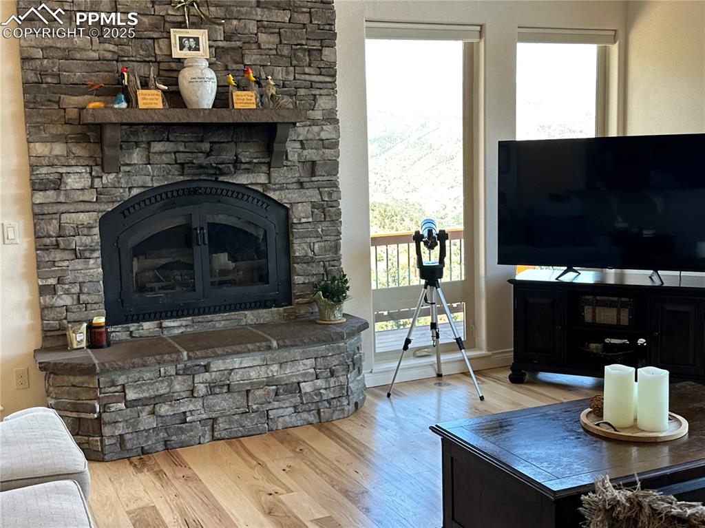 1240 Oak Ridge Road Manitou Springs, CO 80829 - Photo 6 of 17 a living room with furniture a flat screen tv and a fireplace