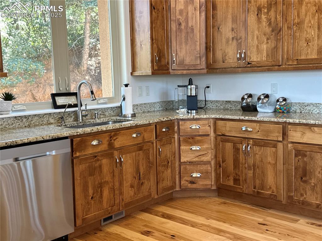 1240 Oak Ridge Road Manitou Springs, CO 80829 - Photo 8 of 17 a kitchen with granite countertop wooden cabinets a sink and dishwasher