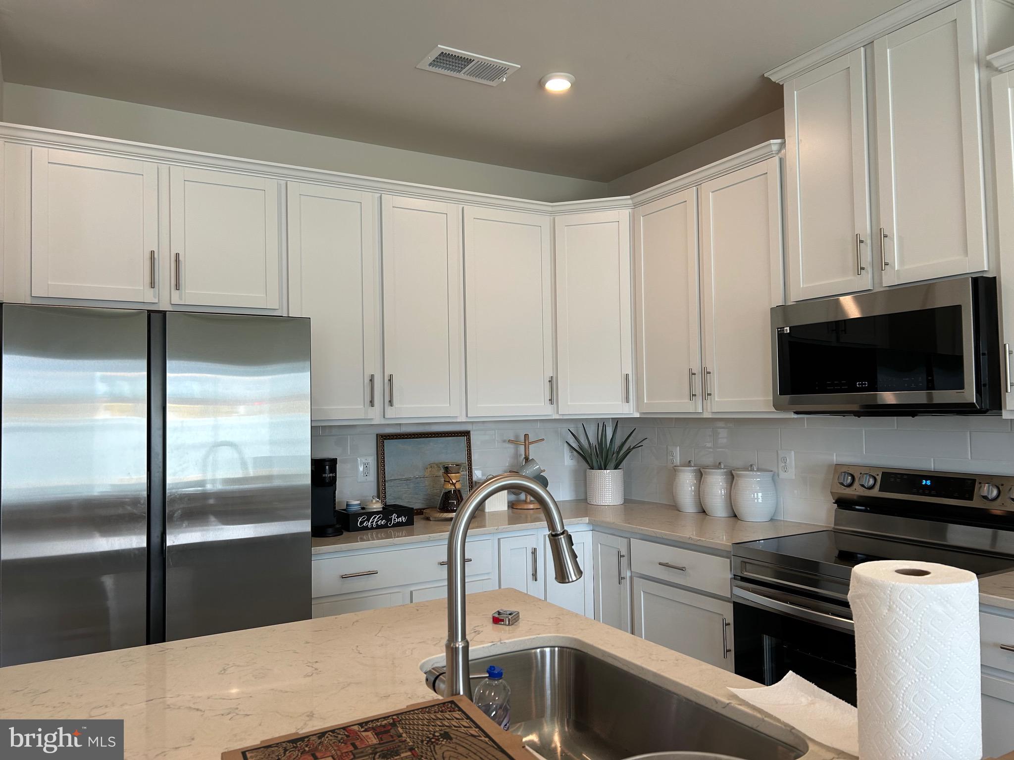 265 Baker Drive Luray, VA 22835 - Photo 4 of 22 a kitchen with a sink stainless steel appliances and white cabinets
