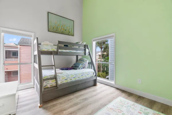 a bedroom with a bed and wooden floor
