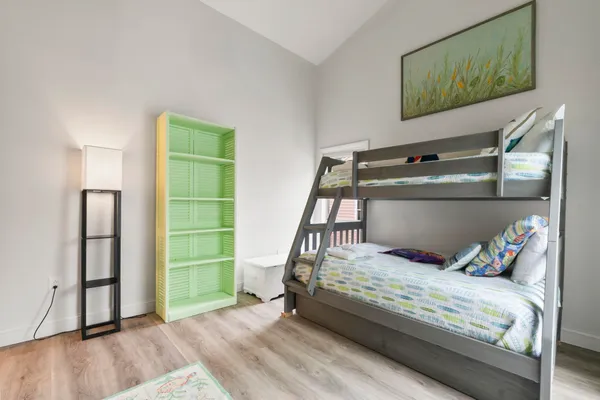 a bedroom with a bed and a mirror