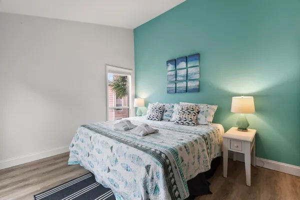 a bedroom with a bed and wooden floor