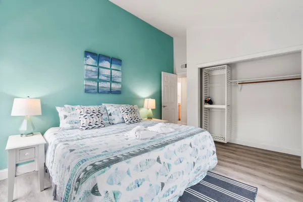 a bedroom with a bed and a lamp