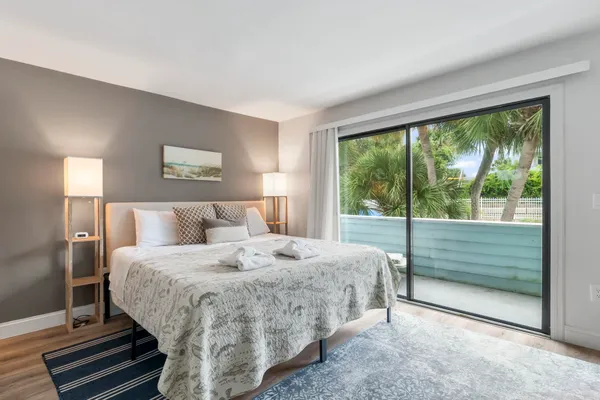 a bedroom with a bed and a large window