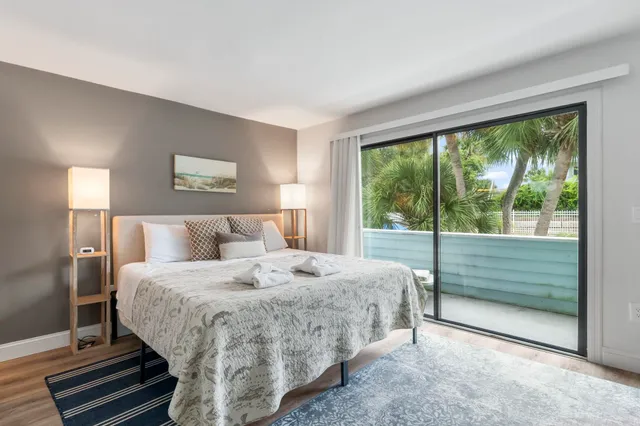 a bedroom with a bed and a large window