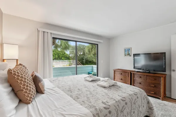 a bedroom with a bed and a flat screen tv