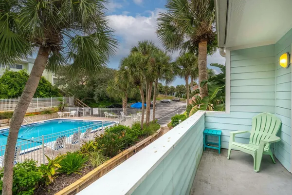 a view of swimming pool with a patio and a garden