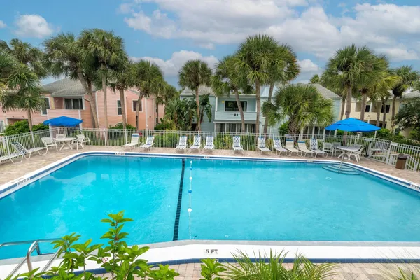 a view of swimming pool with outdoor seating and a pathway