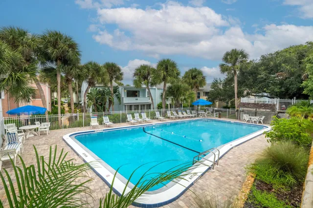 a view of swimming pool with outdoor seating and plants
