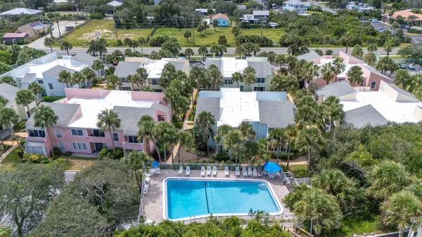 an aerial view of a house with a garden and swimming pool