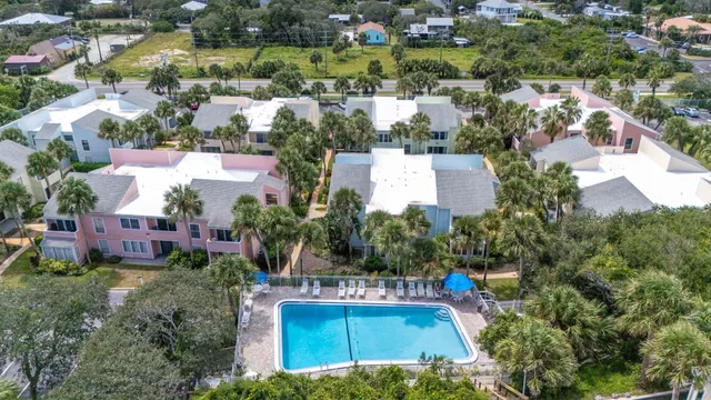 an aerial view of a house with a garden and swimming pool