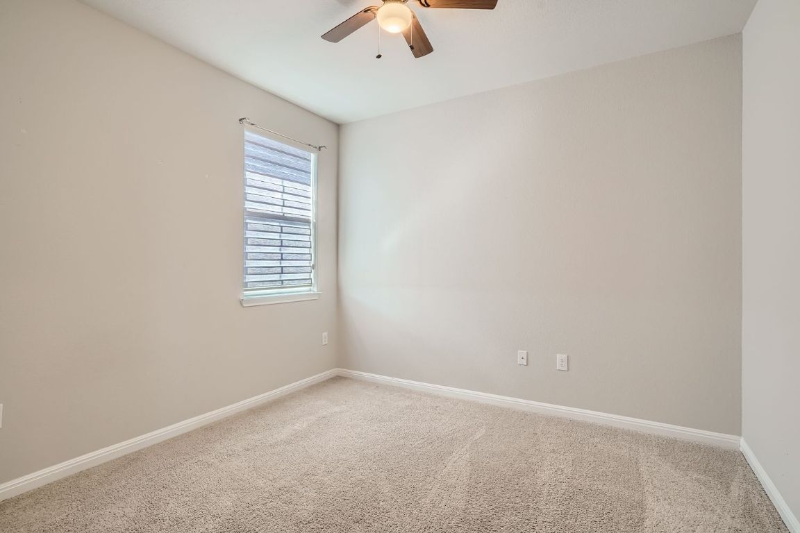 403 Epiphany Lane Pflugerville, TX 78660 - Photo 19 of 29 an empty room with a window and a ceiling fan