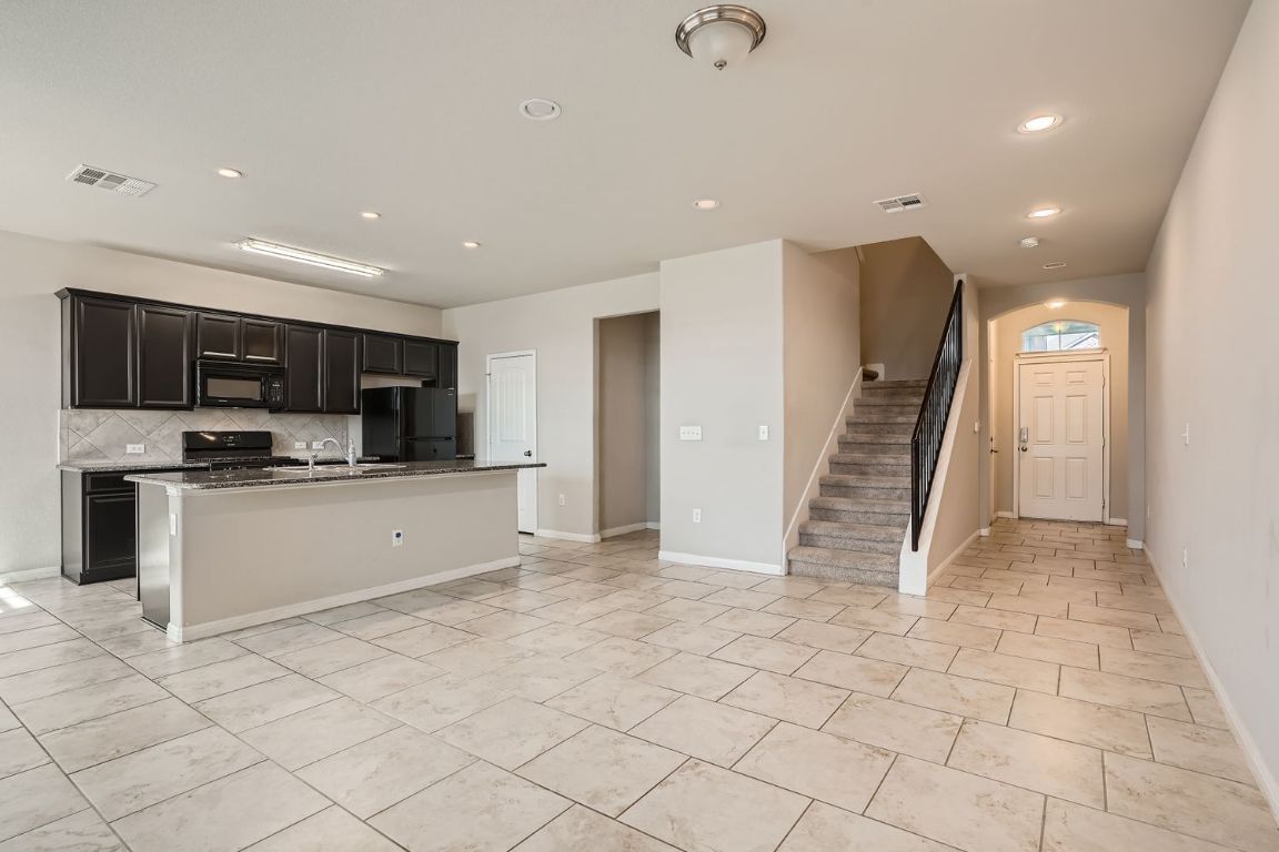 403 Epiphany Lane Pflugerville, TX 78660 - Photo 2 of 29 a view of kitchen with stainless steel appliances refrigerator oven and cabinets