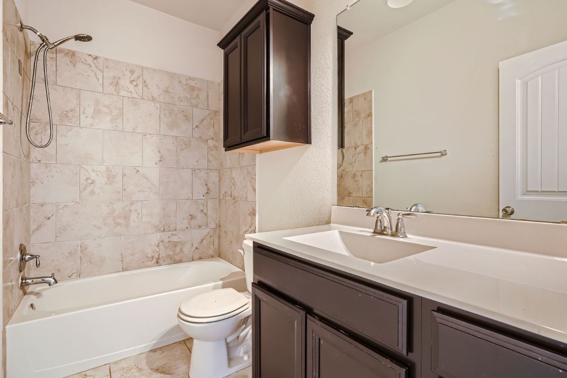 403 Epiphany Lane Pflugerville, TX 78660 - Photo 4 of 29 a bathroom with a sink a toilet and shower