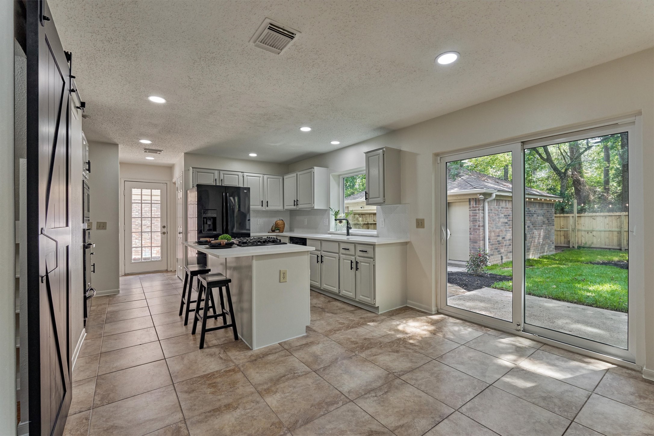 71 Breezy Point Place Spring, TX 77381 - Photo 15 of 40 Welcome to your updated Kitchen! Quartz counters, Eat-at Island, Gas cooktop. Pantry with barn door!