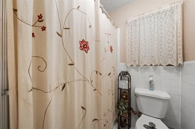 a bathroom with a toilet and a shower