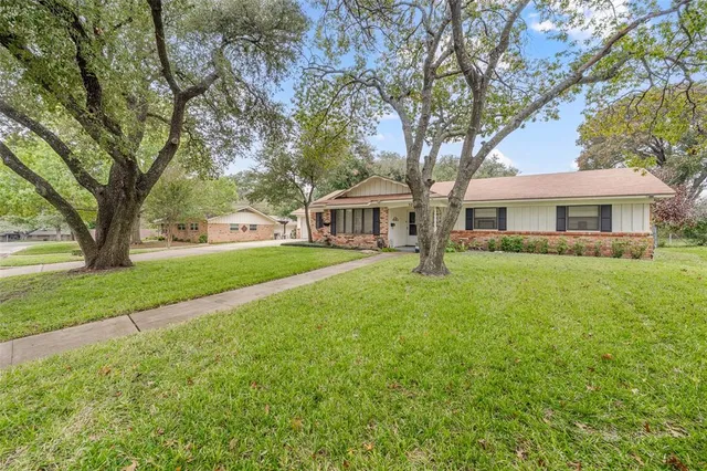 a house view with swimming pool and garden