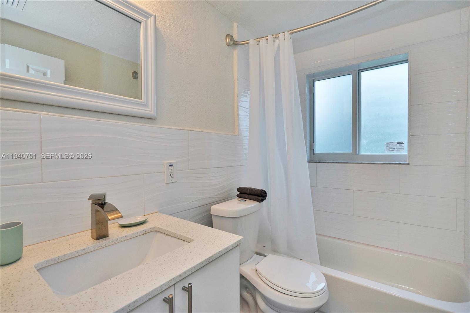 60 Northwest 76th Street, Unit 16 Miami, FL 33150 - Photo 15 of 23 a bathroom with a sink a toilet and shower