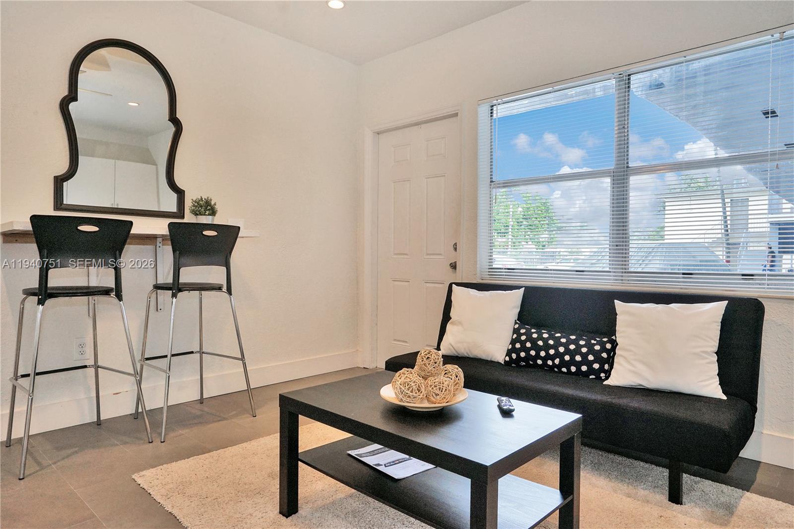60 Northwest 76th Street, Unit 16 Miami, FL 33150 - Photo 17 of 23 a living room with furniture and window