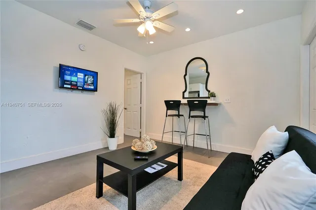 a kitchen with microwave a stove and cabinets