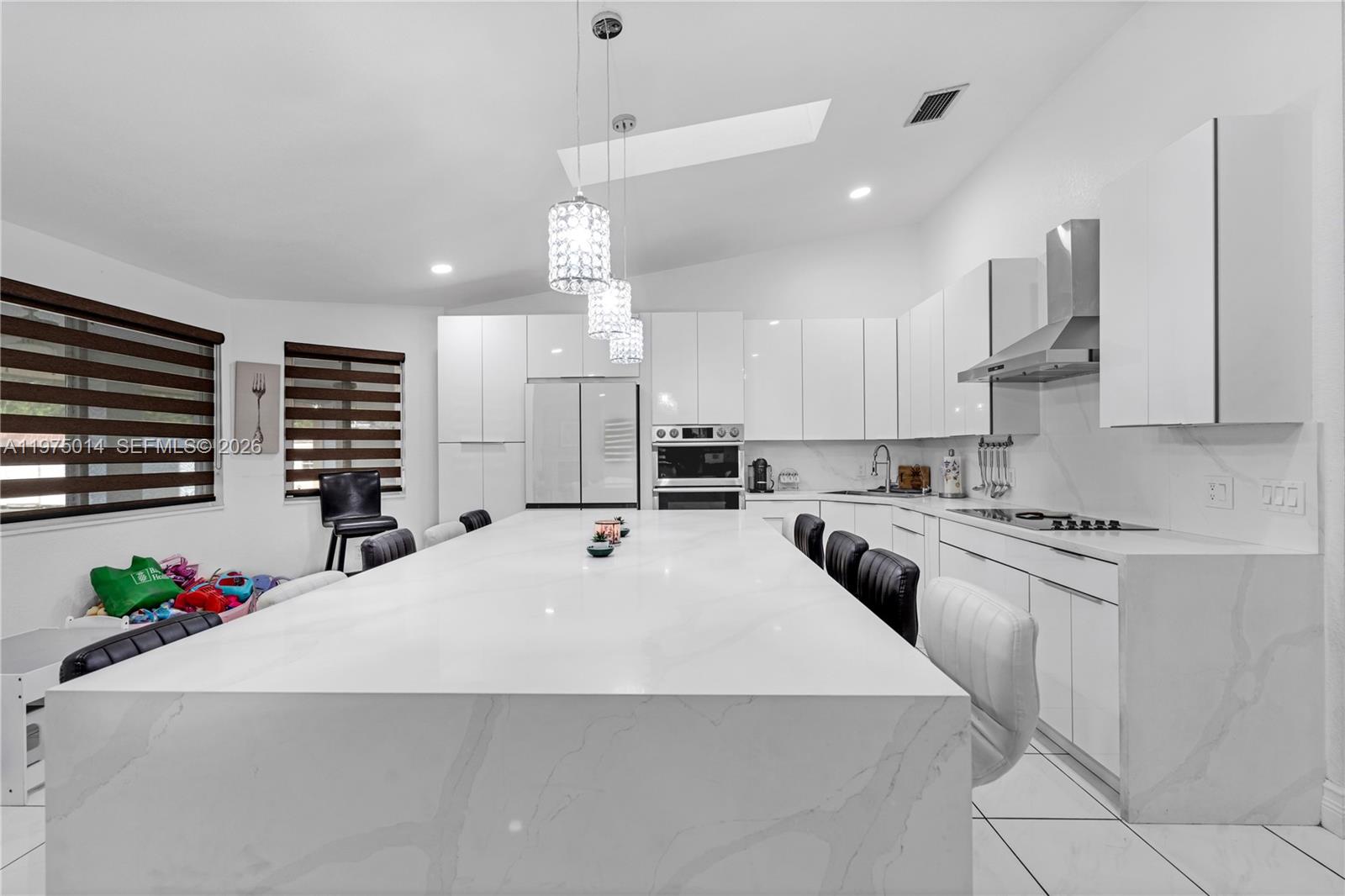 20825 Southwest 242nd Street Homestead, FL 33031 - Photo 14 of 52 a large kitchen with kitchen island a sink stainless steel appliances and cabinets