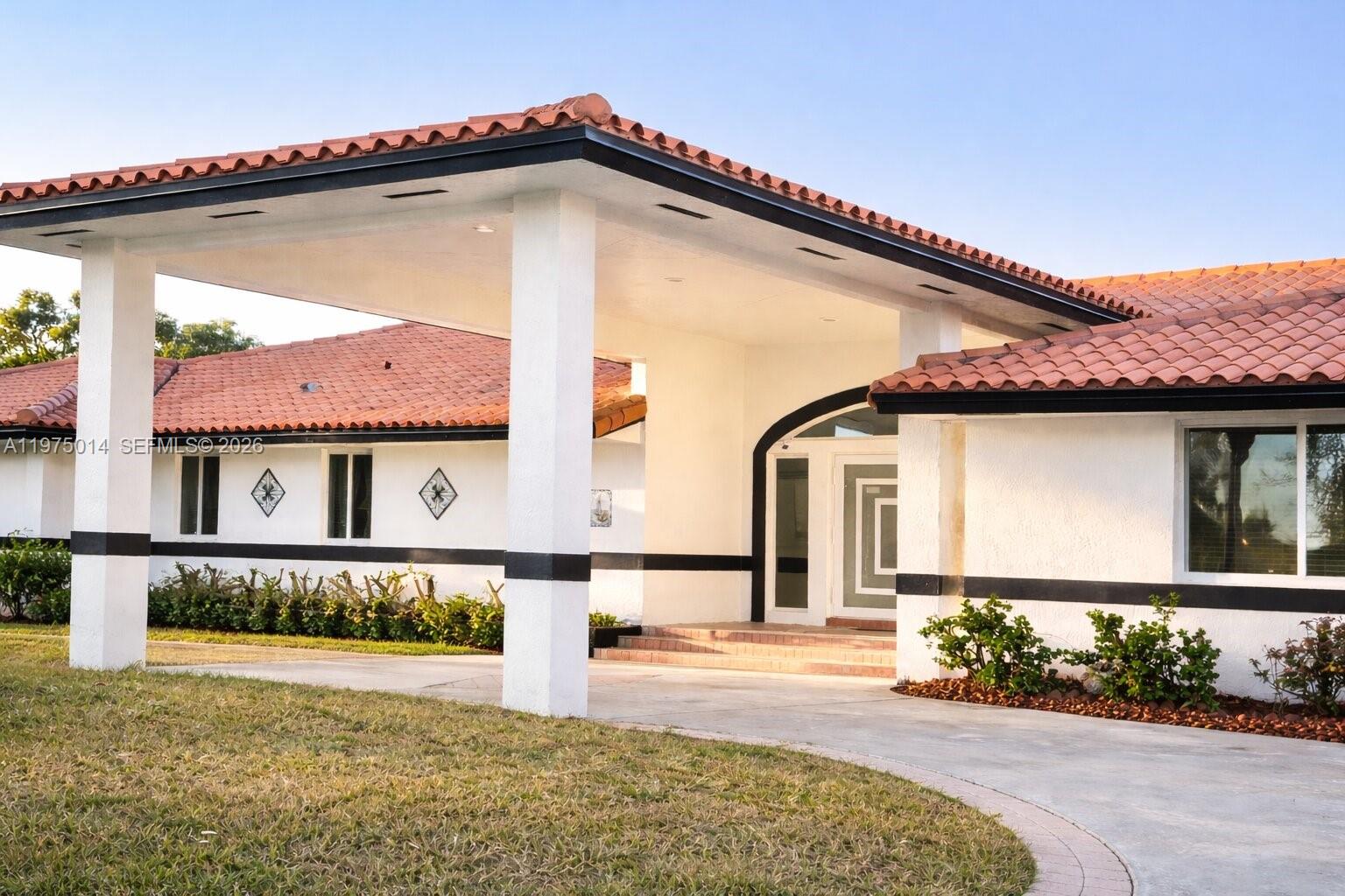 20825 Southwest 242nd Street Homestead, FL 33031 - Photo 3 of 52 a front view of a house with yard